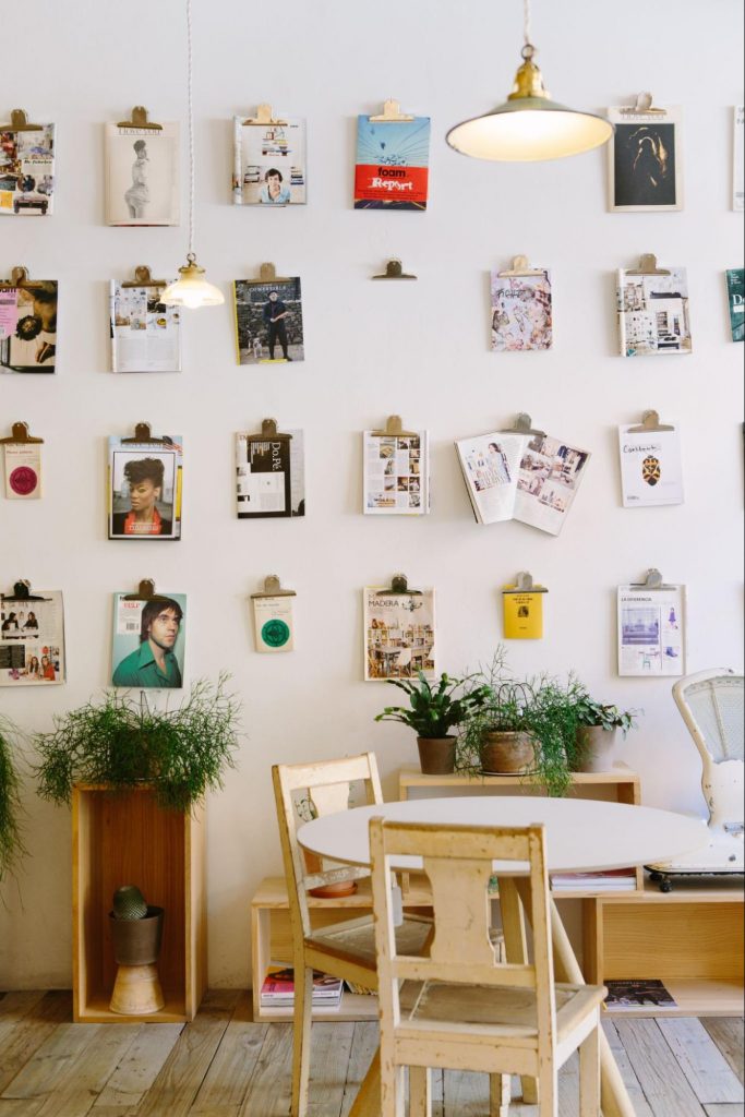pictures and magazines displayed on a white wall